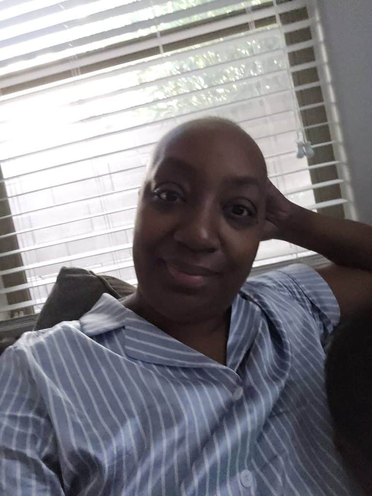 Image of Clarissa relaxing as she takes in sunlight before her upcoming surgery.