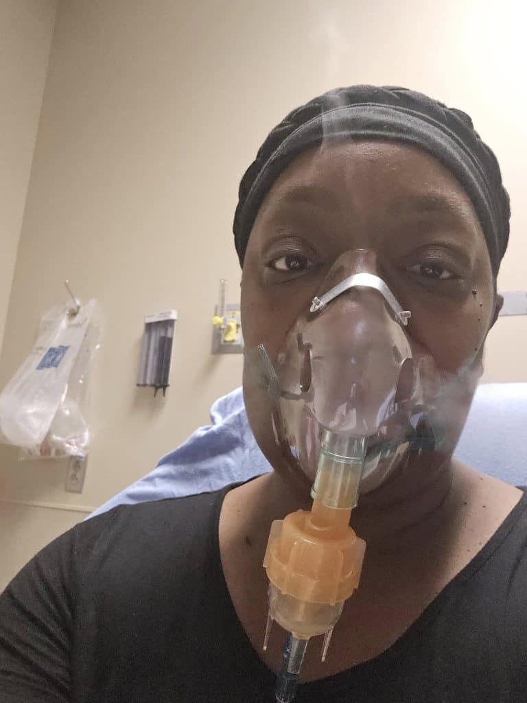 Image of Clarissa receiving a breathing treatment following another pneumonia diagnosis